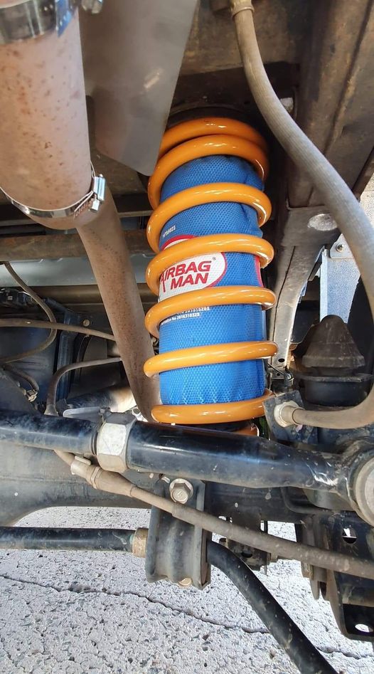 An Airbag Man helper airbag fitted inside a coil spring during a suspension upgrade